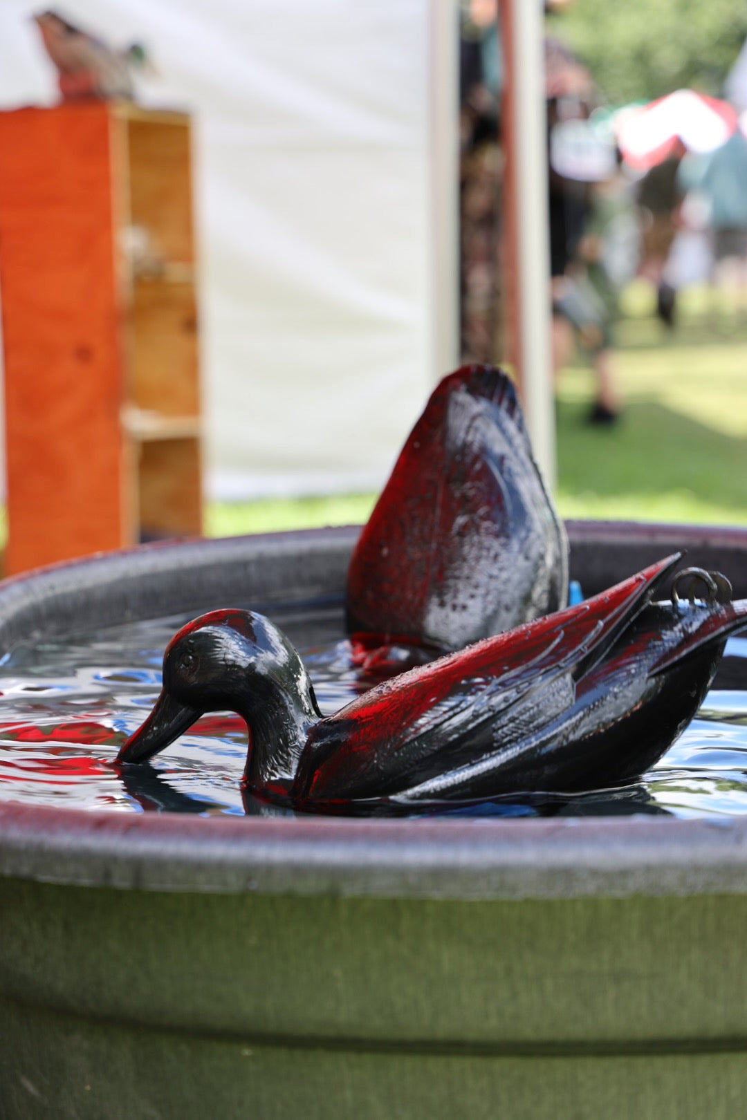 photo of jahpoo flyway deputy motion duck decoys creating water motion inside of a tank at a trade show
