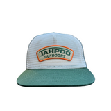 Green and white cap with 'Jahpoo Outdoors' logo on a car dashboard.